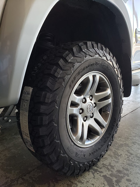 Mechanic mounting a tire in a service bay